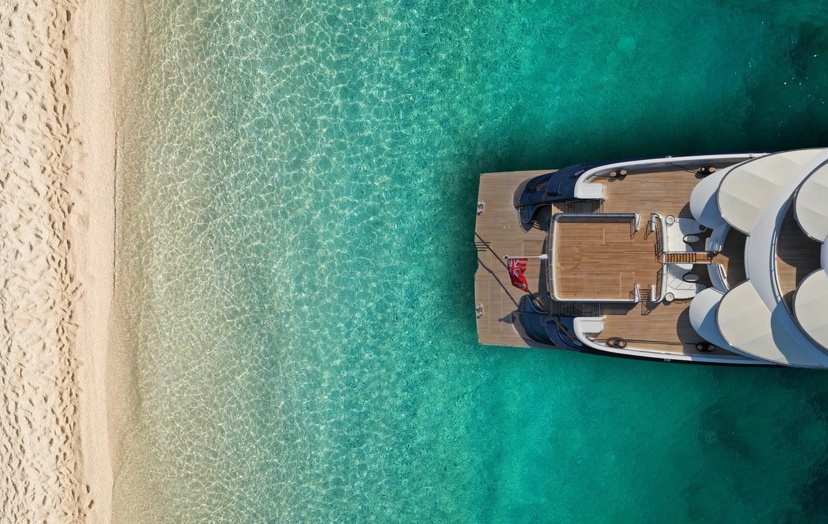 Yacht at anchor over turquoise water in the Caribbean
