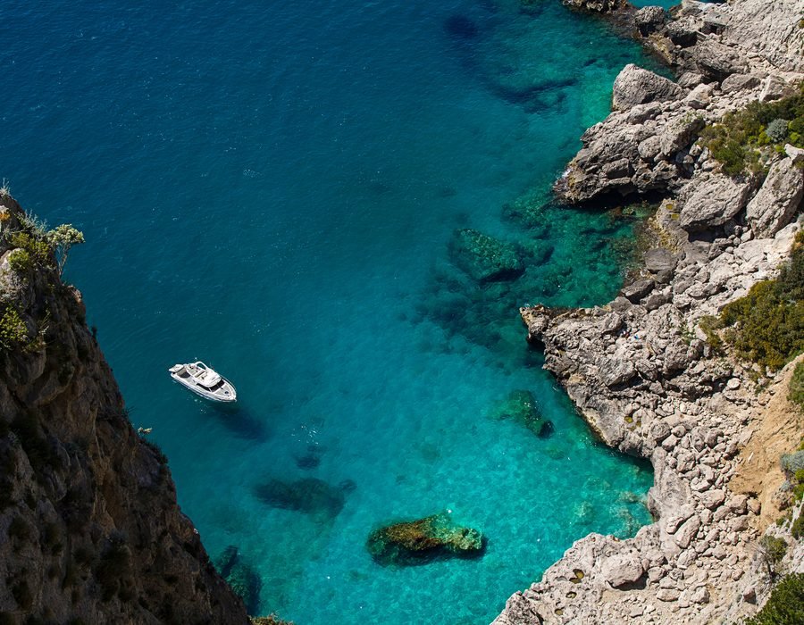 Yacht at anchor in a Mediterranean cove